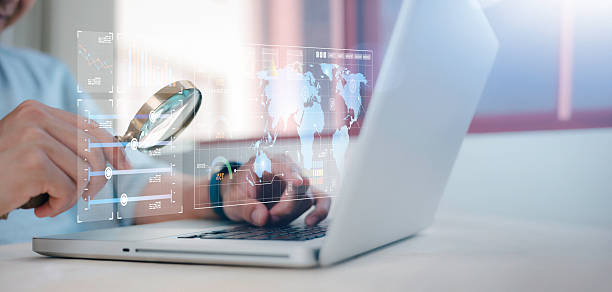 istock businessman holding magnifying glass looking at virtual data chart dashboard in concept of investment data analysis and DMS document audit financial Tax Fraud audit Using Magnifying Glass 2248166844