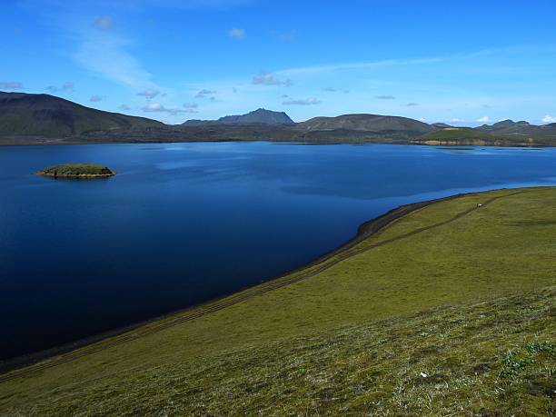 istock Tranquil lake with rolling hills and mountains. 2248167154