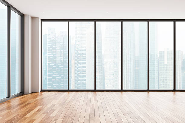 istock Modern empty interior with wooden floor and panoramic city view through large glass windows in bright minimal room concept design. 3D Rendering 2248167484