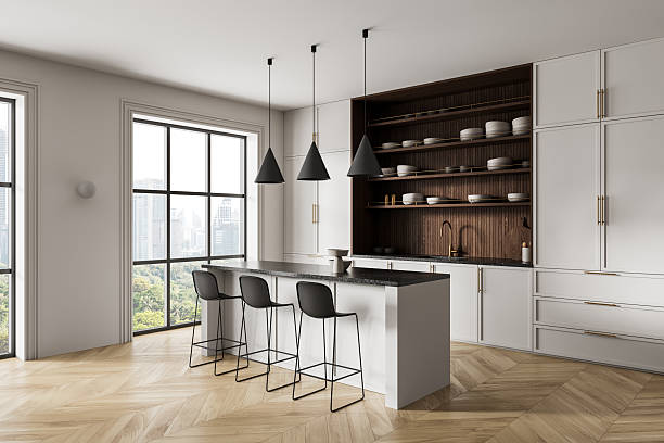istock Modern kitchen interior with white cabinetry, wood accents, and minimalist design featuring large windows and contemporary lighting fixtures. 3D Rendering 2248168880