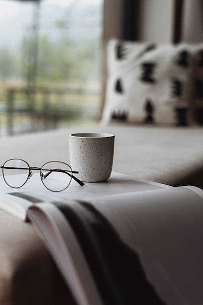 istock Cozy living room day-bed with glasses and a warm cup in a modern home setting 2248169202