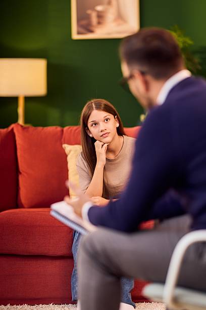 istock Young Woman In Therapy Session With Psychologist In Cozy Office Setting 2248169385
