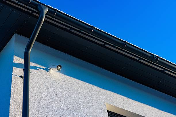 istock A Close-Up View of a Modern Building's Roof Featuring a Security Camera Against a Bright Blue Sky 2248169689