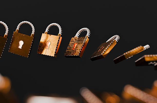 A line of metallic gold padlocks on a dark background conveys themes of security, protection, and privacy. Ideal for stock needs related to cybersecurity, data protection, and safeguarding valuables.