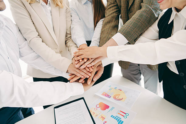 istock Collaborative business team group joining hands in modern workplace boosting motivation for successful teamwork 2248173858