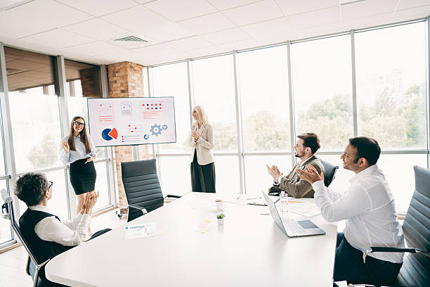 istock Business team applauding during a presentation in a bright office setting showcasing teamwork and professional collaboration 2248173893