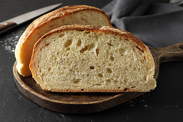 istock Pieces of fresh bread on black table, closeup 2248174230