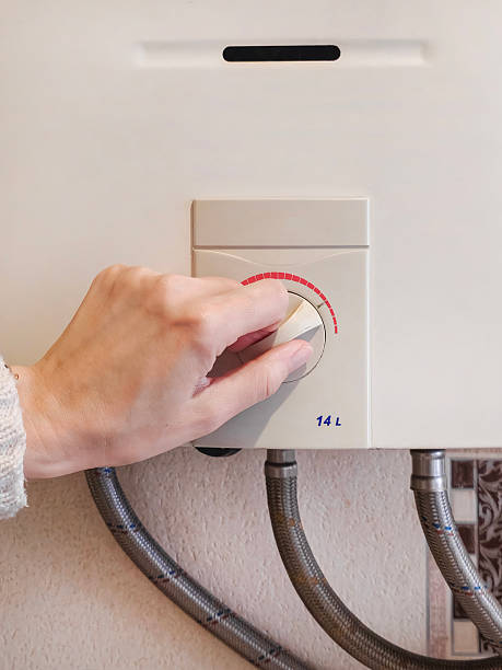 istock manually adjusting the temperature of the water in a gas-fired b 2248174276
