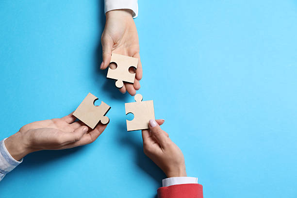 istock Business strategy and teamwork concept. Partners with different puzzle pieces on light blue background, top view. Space for text 2248176348