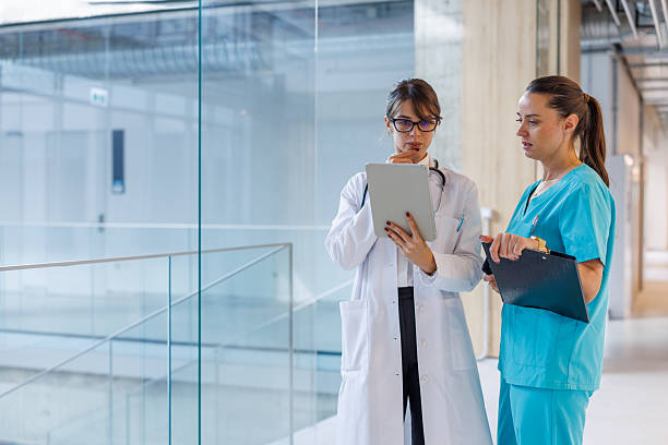 istock Doctors and nurses collaborating in modern hospital corridor 2248177366