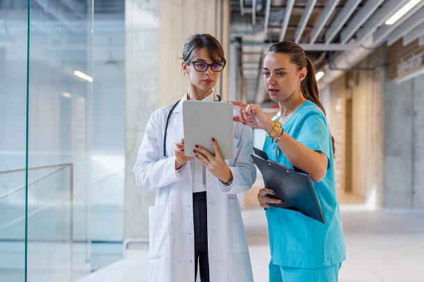 istock Female doctors working together discussing medical information on tablet 2248177442
