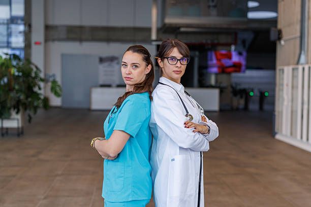 Professional female medical team standing with arms crossed at a hospital