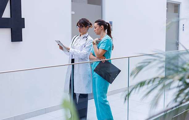 istock Female doctor and nurse discussing patient data on tablet 2248177523