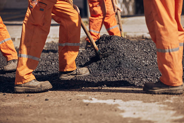 istock Construction worker working on a new asphalt layer on a public street. 2248178631