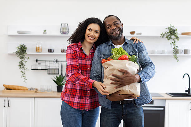 istock Couple with Groceries in Kitchen 2248180768