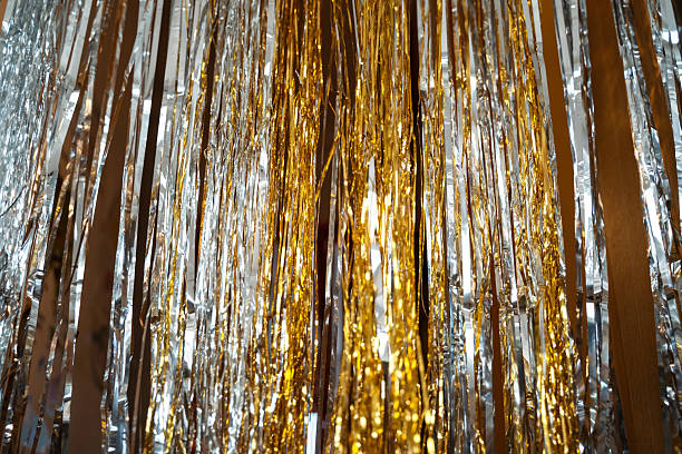 istock Holographic festive background with shiny tinsel and glitter. Gold and silver bokeh create a New Year and Christmas celebration mood. Perfect metallic, colorful holiday texture. 2248181616