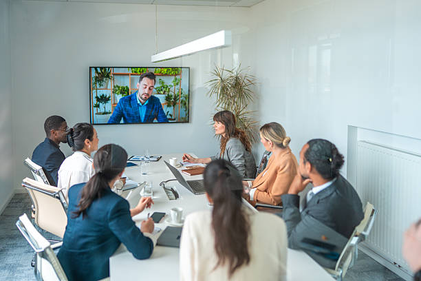 istock Diverse Business Executives Engaged in Video Conference in Modern Bright Boardroom 2248182080