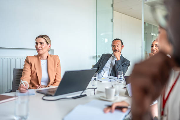 istock Diverse Business Executives Engaged in Collaborative Discussion in Modern Office Boardroom 2248182092