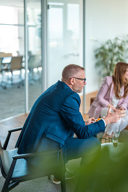 istock Business Professionals Engaging in Discussion in Contemporary Office Space 2248183168