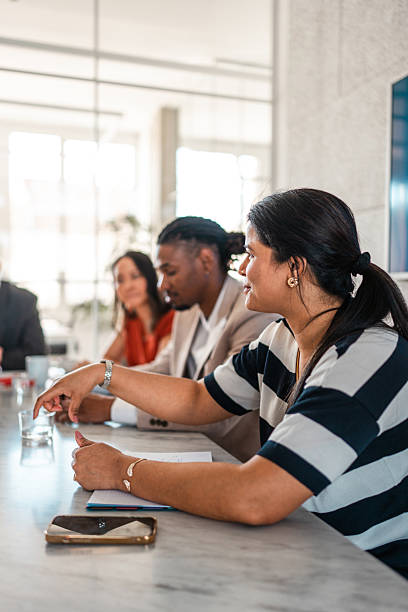 istock Diverse Team Collaborating in Modern Office with Focused Discussion and Professional Attire 2248183712