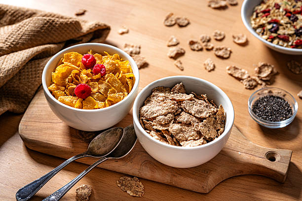 High angle view of two bowls with corn flakes for healthy breakfast or snack. Wholegrain or dietary fiber for wellness and wellbeing of digestive system