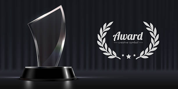 istock Elegant Glass Award Trophy and Laurel Wreath on Dark Stage Background. 2248187244