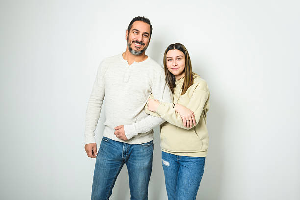 istock father and cute teen isolated on white on studio 2248188838