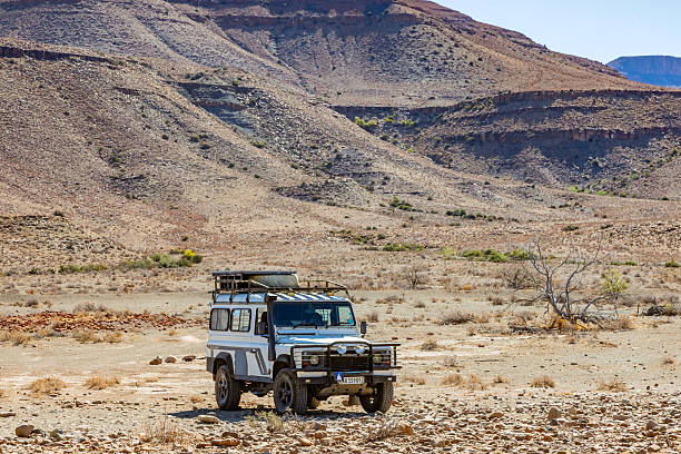 Karoo, South Africa - October 27, 2025: Old Land Rover Defender parked in an arid region