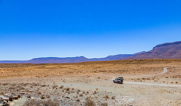 Karoo, South Africa - October 27, 2025: Old Land Rover Defender parked in an arid region
