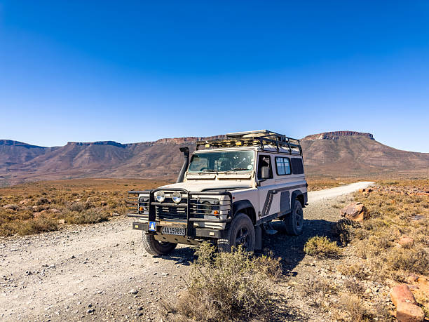 Karoo, South Africa - October 27, 2025: Old Land Rover Defender parked in an arid region