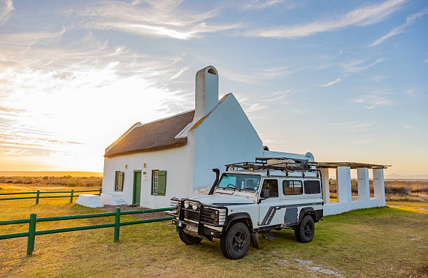 Langebaan, South Africa - November 4, 2025: Old Land Rover Defender parked outside historic building