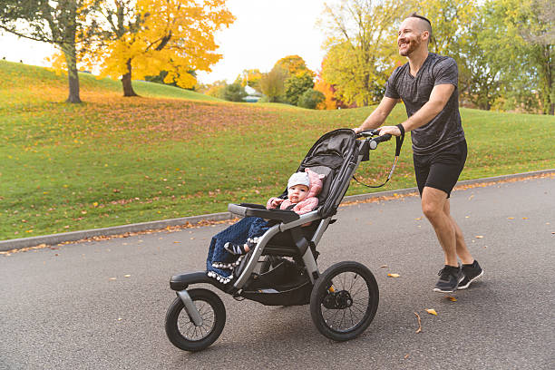 istock man with her daughter in jogging stroller outside in autumn nature 2248190203