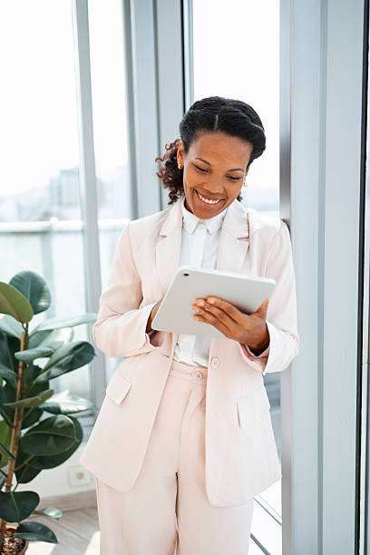 istock Smiling Female Professional Using a Digital Tablet in a Modern Bright Office 2248190290