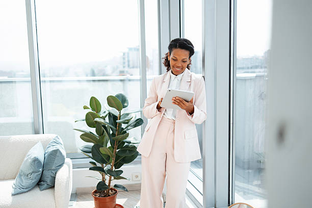 istock Professional woman using tablet in bright and modern office workspace 2248190293