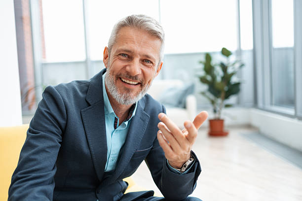 istock Confident businessman smiling during a conversation in a modern office setting 2248190330