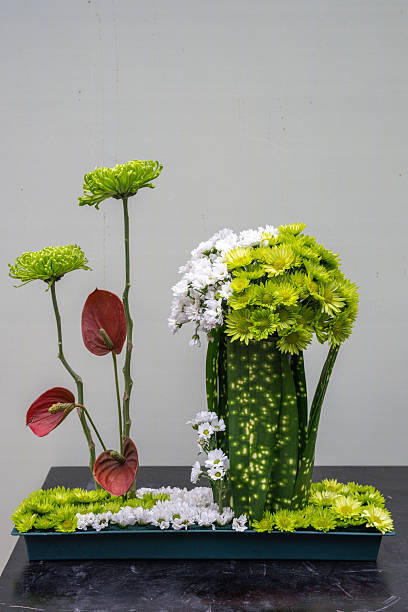 A beautiful flower arrangement in Chengdu, China features vibrant green flowers mixed with white and red accents. The striking display captures the essence of floral artistry and natural beauty.