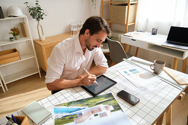 istock Architect drawing house blueprint on digital tablet 2248193357