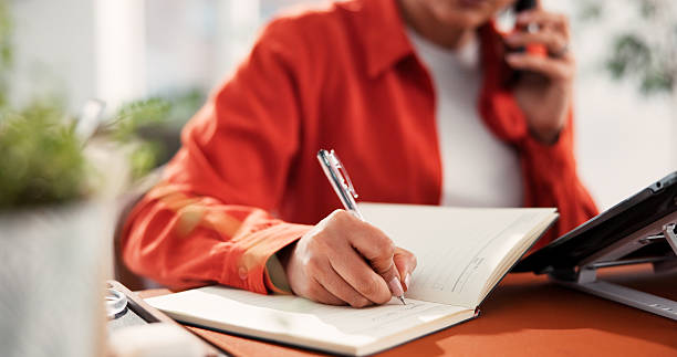 istock Phone call, hands and woman writing in notebook for client info, fabric order or schedule in office. Mobile, talk and fashion designer with journal for design idea, business list or production update 2248196638