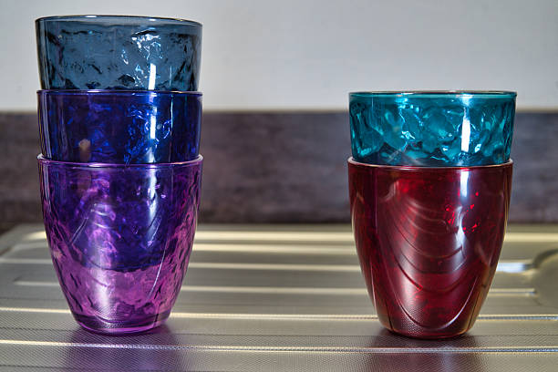 Coloured glasses stacked beside the sink