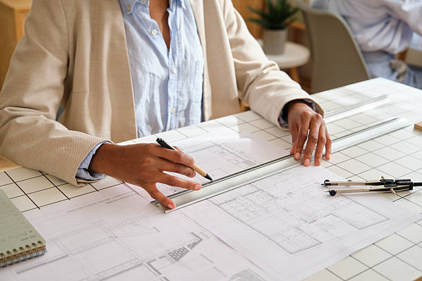 istock Architect designing commercial building blueprint in office 2248196980