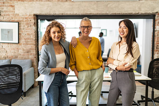 istock Diverse businesswomen smiling in modern office environment 2248197381