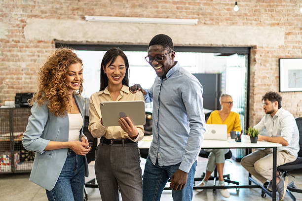 istock Diverse business team collaborating and laughing in modern office 2248197800