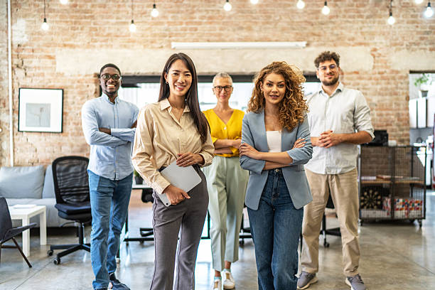 istock Diverse business team standing together in modern office 2248197905