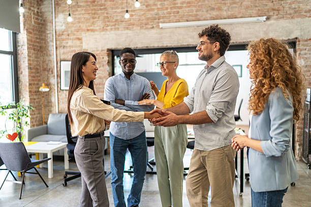istock Business people shaking hands celebrating partnership in modern office 2248197909