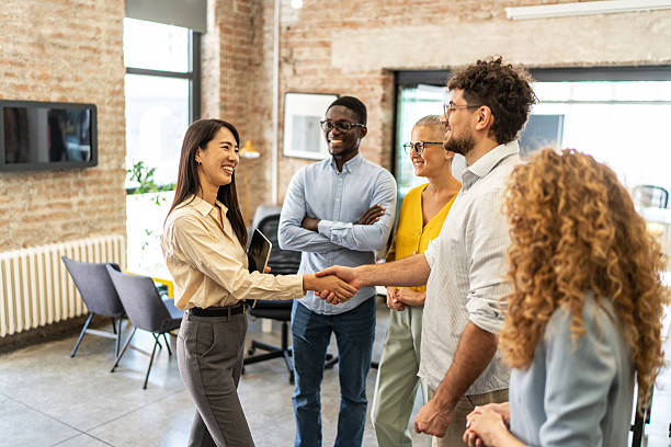 istock Diverse business professionals shaking hands in office meeting 2248197968