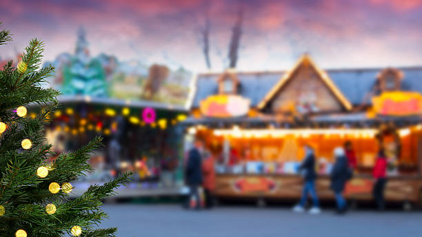 istock illuminated christmas tree in foreground isolated on blurred christmas market background with copy space 2248198304