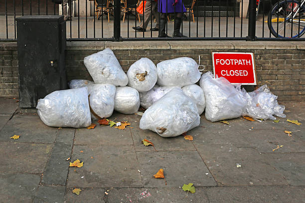 Four bin bags on a London pavement