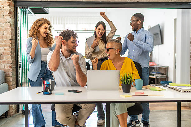 istock Diverse business team celebrating success in modern office 2248199117