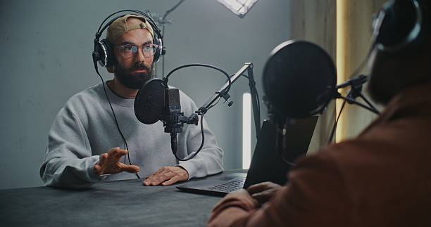 istock Two Men Wearing Headphones and Talking Into Professional Mics, Exchange Ideas 2248199355
