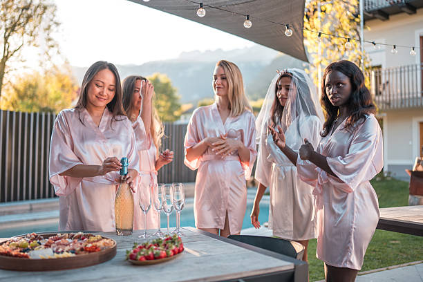 istock Champagne Toast in Silk Robes 2248200132